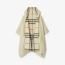 Designer cape over a tailored silhouette in quiet neutral light for THE NOTICE by THE GRAY CRAB
